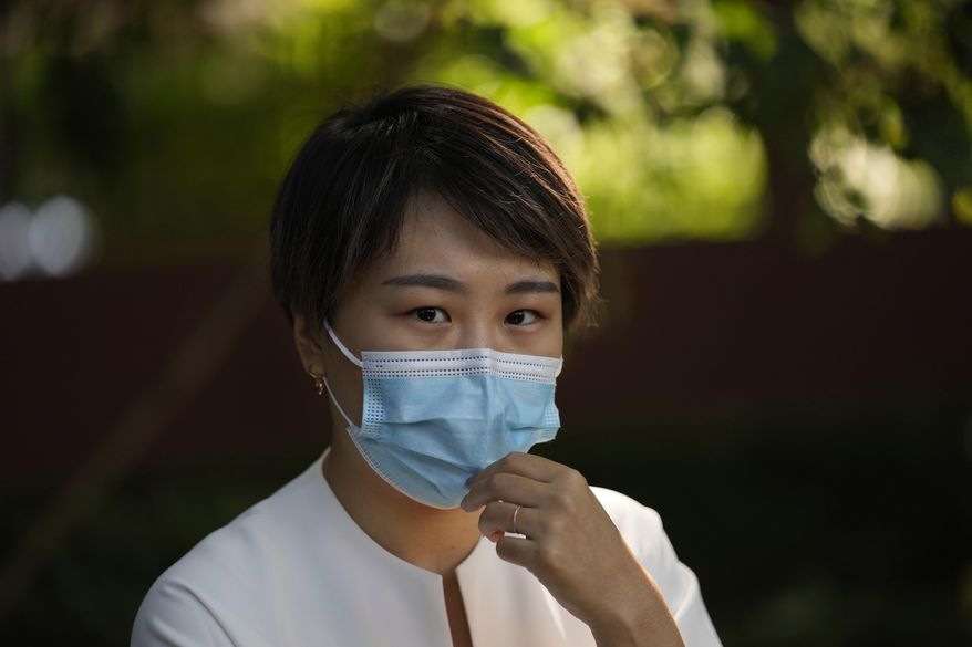 FILE - Teresa Xu, an unmarried woman suing for the right to freeze her eggs, prepares to attend a court session at the Chaoyang People's Court in Beijing, on Sept. 17, 2021. (AP Photo/Ng Han Guan, File)