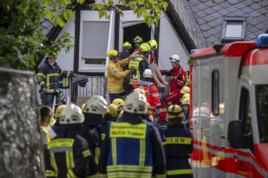 A person is rescued from the partially collapsed hotel in Kroev, Germany Wednesday, Aug. 7, 2024. (Harald Tittel/dpa via AP)