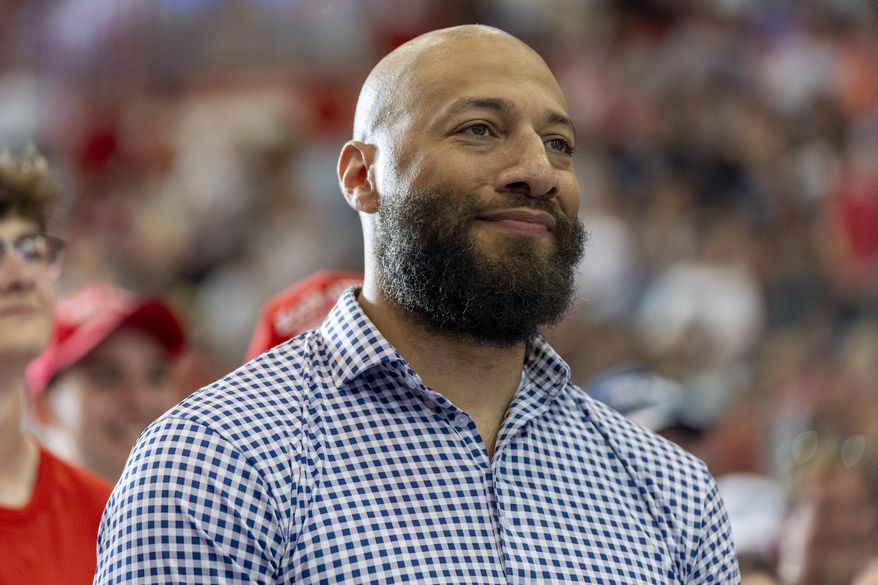 Royce White, candidate for U.S. Senate, listens as Republican presidential candidate former President Donald Trump speaks at a campaign rally, July 27, 2024, in St. Cloud, Minn. (AP Photo/Alex Brandon)