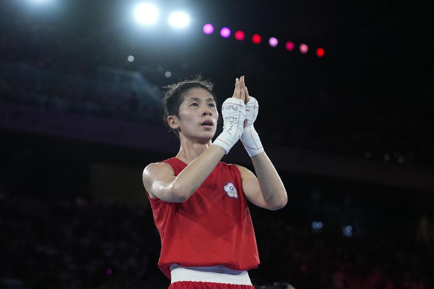 Taiwan's Lin Yu-ting celebrates after defeating Poland's Julia Szeremeta in their women's 57 kg final boxing match at the 2024 Summer Olympics, Saturday, Aug. 10, 2024, in Paris, France. (AP Photo/John Locher)
