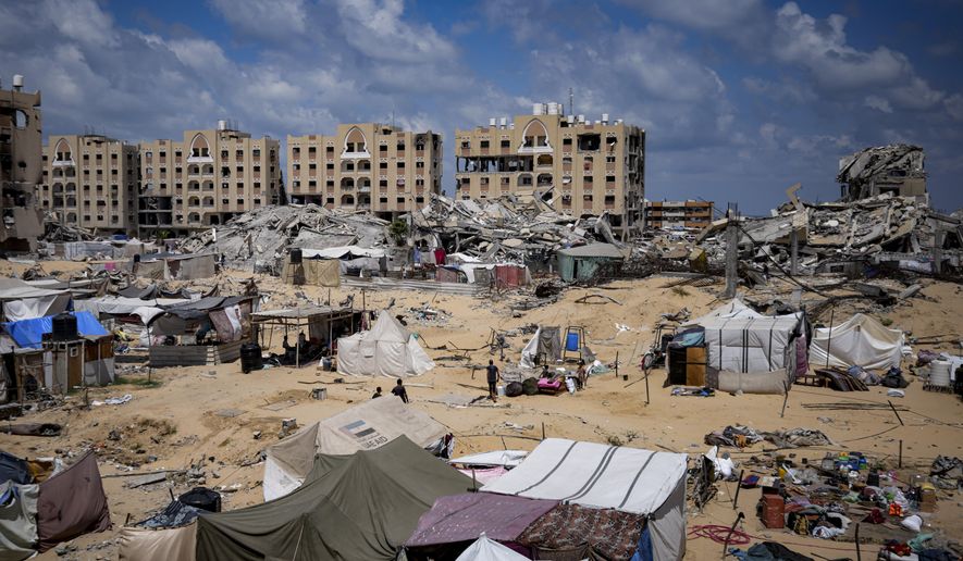Palestinians displaced by the Israeli air and ground offensive on the Gaza Strip flee from Hamad City, following an evacuation order by the Israeli army to leave parts of the southern area of Khan Younis, Sunday, Aug. 11, 2024. (AP Photo/Abdel Kareem Hana)