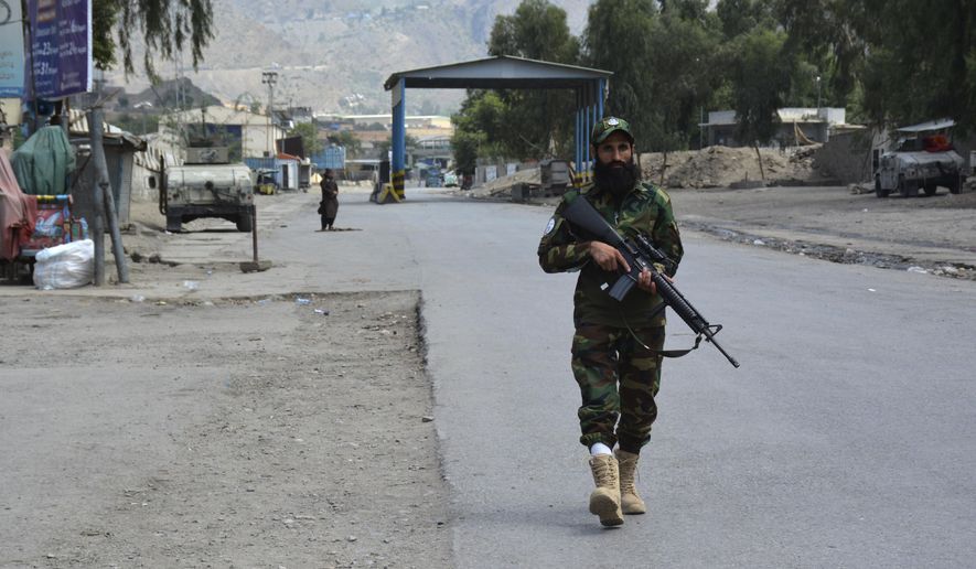 A soldier of Afghan Taliban forces patrols on the vicinity of Torkham border of Nangarhar province, east of Kabul, Afghanistan, Tuesday, Aug. 13, 2024. Pakistani and Afghan Taliban forces traded cross-border fire near a key northwestern crossing, killing a woman and two children on the Afghan side of the border, officials said Tuesday. (AP Photo/Shafiullah Kakar)