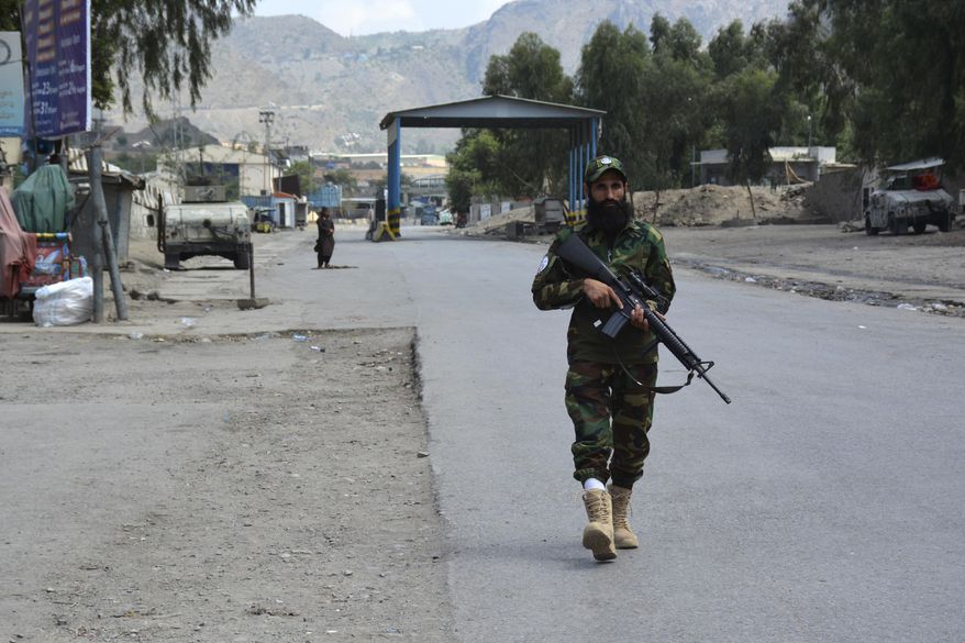 A soldier of Afghan Taliban forces patrols on the vicinity of Torkham border of Nangarhar province, east of Kabul, Afghanistan, Tuesday, Aug. 13, 2024. Pakistani and Afghan Taliban forces traded cross-border fire near a key northwestern crossing, killing a woman and two children on the Afghan side of the border, officials said Tuesday. (AP Photo/Shafiullah Kakar)