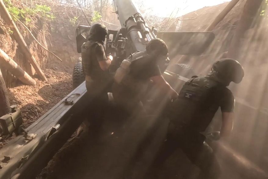 In this photo taken from a video released by the Russian Defense Ministry on Thursday, Aug. 15, 2024, Russian soldiers load Giatsint-B self-propelled gun at an undisclosed location. (Russian Defense Ministry Press Service photo via AP) ** FILE **