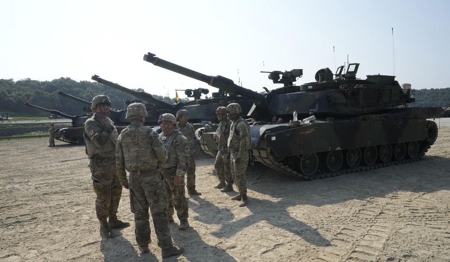 U.S. Army soldiers from the 1st Armored Brigade Combat Team stand by their M1A2 Abrams tanks as they prepare to attend a live firing drill at Rodriguez Live Fire Complex in Pocheon, South Korea, Wednesday, Aug. 14, 2024. (AP Photo/Ahn Young-joon) ** FILE **