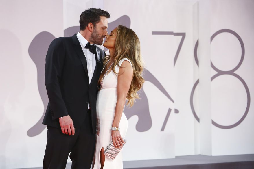 Jennifer Lopez, right, and Ben Affleck kiss at the premiere of the film "The Last Duel" during the Venice Film Festival in Venice, Italy, on Sept. 10, 2021. (Photo by Joel C Ryan/Invision/AP) **FILE**