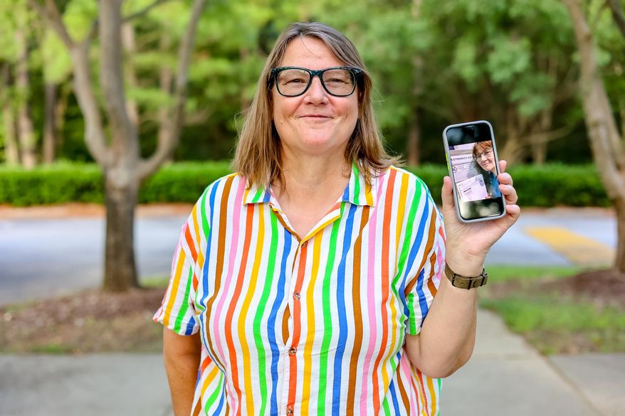 Susan Hogarth holds up her phone, July 24, 2024, in Raleigh, N.C., showing a selfie she took in a N.C. ballot box. Hogarth is suing the state elections board for laws prohibiting most photography of voters and ballots in North Carolina. (Shutter by Nitish LLC/Foundation for Individual Rights and Expression via AP)