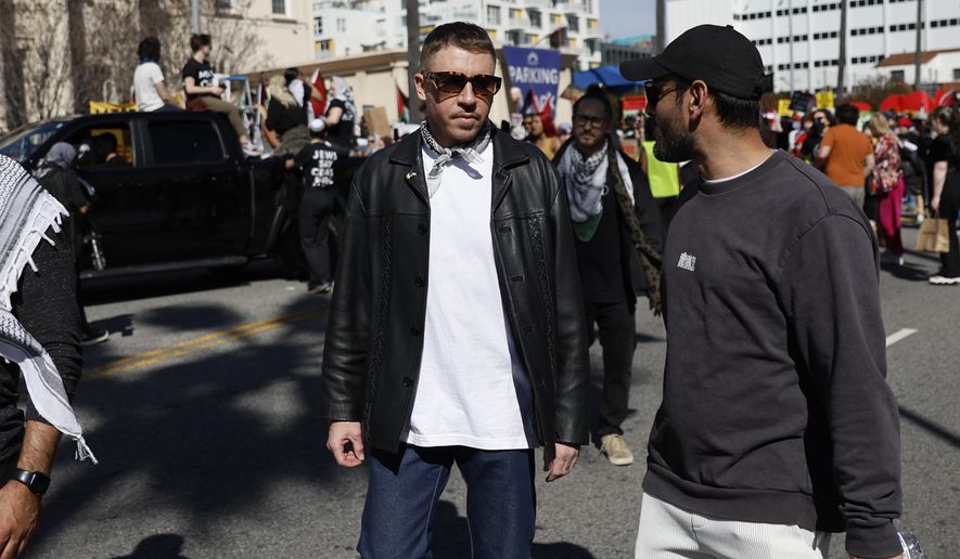 U.S. rapper Macklemore, center, attends a demonstration near the Dolby Theatre, where the 96th Academy Awards ceremony is held on Sunday, March 10, 2024, in the Hollywood section of Los Angeles, in support of Palestinians calling for a ceasefire in the Gaza Strip. (AP Photo/Etienne Laurent) **FILE**