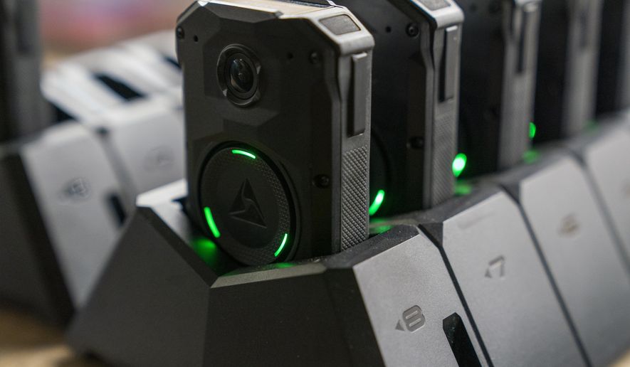 Axon body cameras charge on a docking station at Oklahoma City police headquarters on Friday, May 31, 2024 in Oklahoma City, Oklahoma. (AP Photo/Nick Oxford)