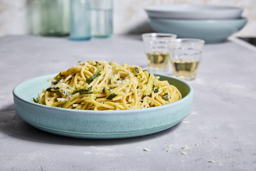 This image released by Milk Street shows a recipe for pasta with pecorino-zucchini sauce and basil. (Milk Street via AP)