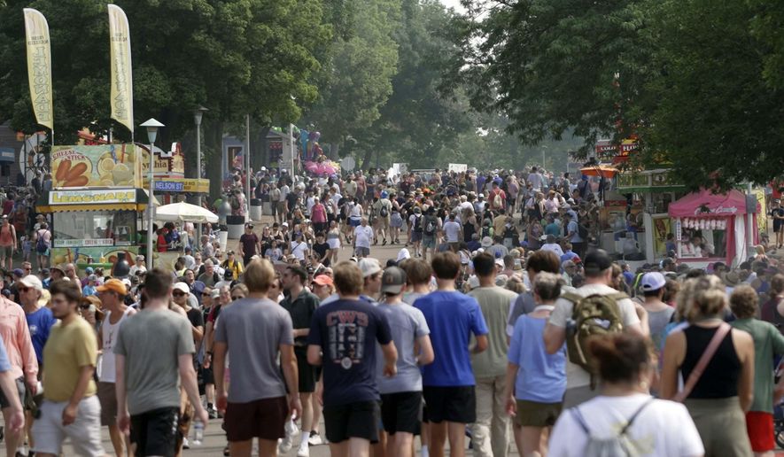 Crowds make their way through the Minnesota State Fair in Falcon Heights, Minn., on Monday, Aug. 26, 2024. (AP Photo/Mark Vancleave)