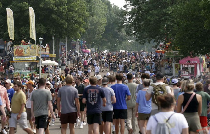 Crowds make their way through the Minnesota State Fair in Falcon Heights, Minn., on Monday, Aug. 26, 2024. (AP Photo/Mark Vancleave)