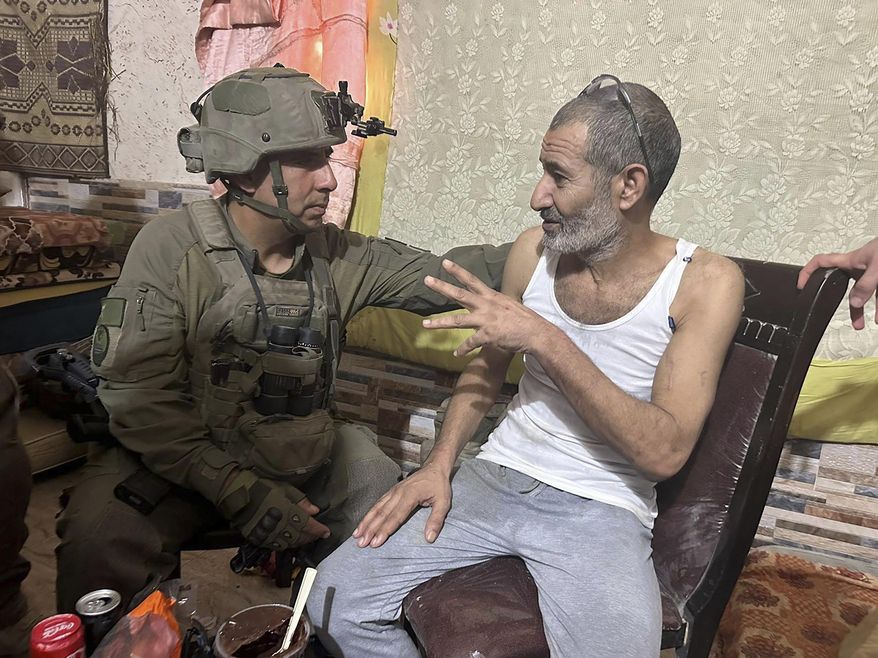 FILE - In this photo released by Israeli Defense Forces on Aug. 27, 2024, Qaid Farhan Alkadi, right, and the commanding officer of the 162nd Division, Brig. Gen. Itzik Cohen, talk after a rescue operation to free Alkadi. (Israeli Defense Forces via AP, File)