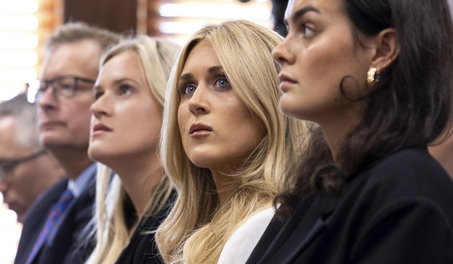 Former collegiate swimmers Kaitlynn Wheeler, from third left, Riley Gaines, and Grace Countie, who competed in Georgia but aren't from the state, prepare to testify in opposition to transgender athletes in women's sports in front of the state senate's Special Committee on Protecting Women's Sports at the Capitol in Atlanta, Tuesday, Aug. 27, 2024. (Arvin Temkar/Atlanta Journal-Constitution via AP) **FILE**