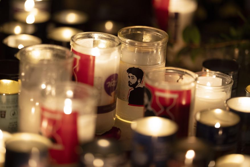 A candle with an image depicting the slain hostage Hersh Goldberg-Polin is seen on a table during a vigil in his memory in Jerusalem, Israel, Sunday, Sept. 1, 2024. (AP Photo/Leo Correa)