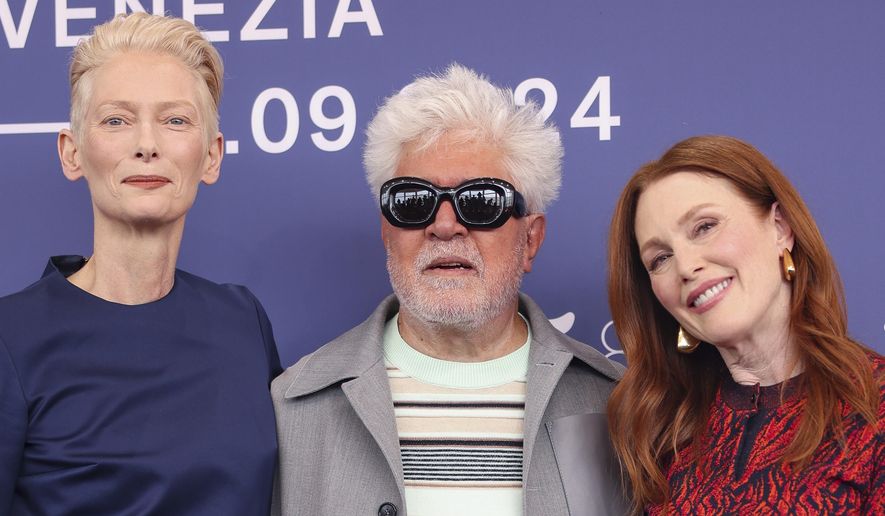Tilda Swinton, from left, director Pedro Almodovar, and Julianne Moore pose for photographers at the photo call for the film 'The Room Next Door' during the 81st edition of the Venice Film Festival in Venice, Italy, on Monday, Sept. 2, 2024. (Photo by Vianney Le Caer/Invision/AP)