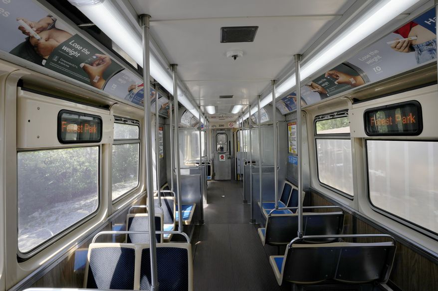 A Chicago Transit Authority Blue Line train car rides empty as it approaches the Forest Park, Ill., station Tuesday, Sept. 3, 2024, in Forest Park. (AP Photo/Charles Rex Arbogast)
