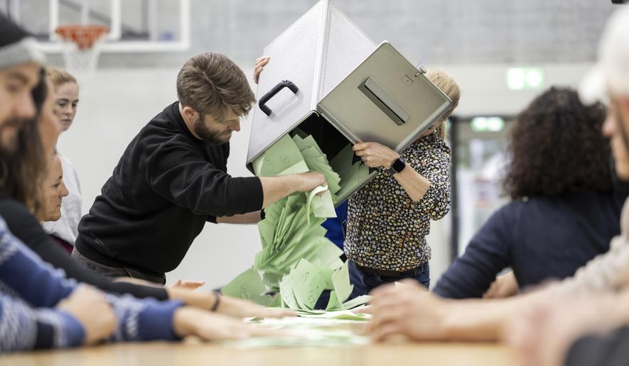 Election counting staff empty a ballot box to begin counting votes at a polling station in Berne, Switzerland, on Oct. 22, 2023. (Alessandro della Valle/Keystone via AP, File)