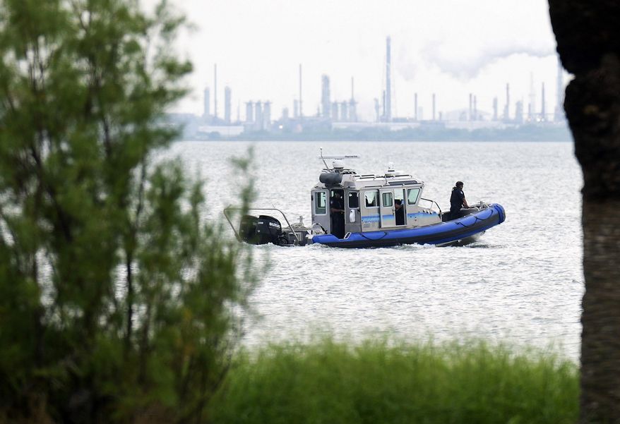 A police boat patrols near where a car was pulled out of the Galveston Ship Channel Tuesday, Sept. 3, 2024 in Galveston, Texas, following the fatal shooting of a Texas deputy constable in Houston. A suspect led authorities on a 60 miles chase that ended in the waters off Galveston, where the man tried swimming away to evade arrest before being captured with the help of a marine unit, according to the Port of Galveston Police Department. (Elizabeth Conley/Houston Chronicle via AP)