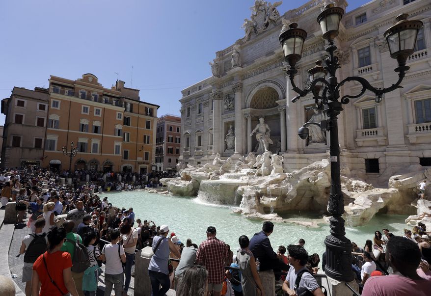 Tourists admire the Trevi Fountain in Rome, June 7, 2017. (AP Photo/Gregorio Borgia, File)