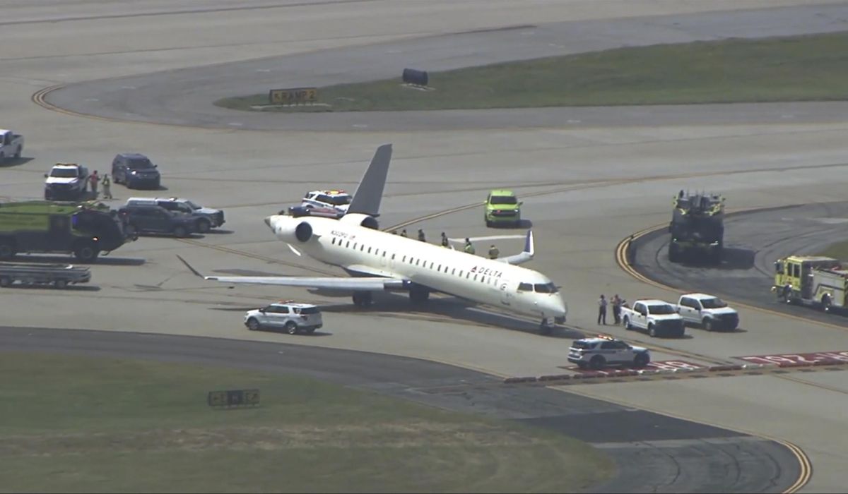 NextImg:Two Delta planes collide on an Atlanta taxiway, knocking the tail off one