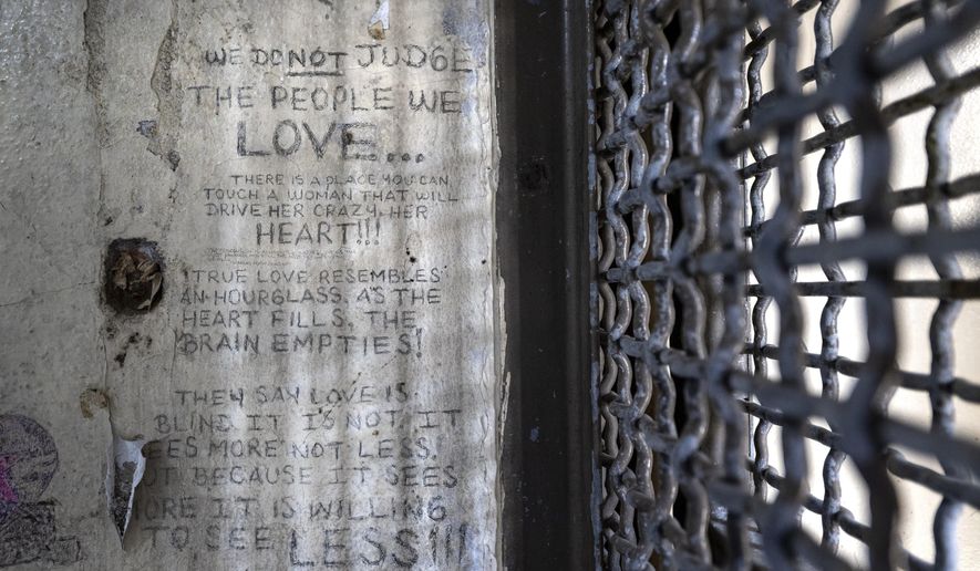 Graffiti remains on the walls of cell No. 126 in the historic,= Kansas State Penitentiary, also called the Lansing Correctional Facility, during a media tour, Monday, Sept. 9, 2024, in Lansing, Kan. (Tammy Ljungblad/The Kansas City Star via AP)