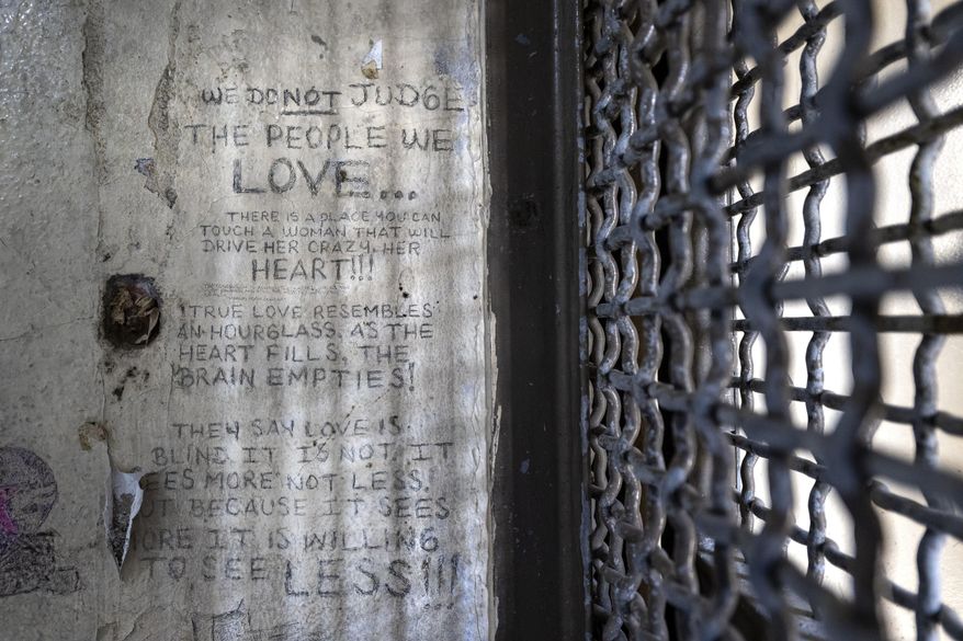 Graffiti remains on the walls of cell No. 126 in the historic,= Kansas State Penitentiary, also called the Lansing Correctional Facility, during a media tour, Monday, Sept. 9, 2024, in Lansing, Kan. (Tammy Ljungblad/The Kansas City Star via AP)
