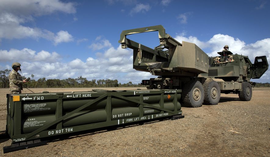 In this image provided by the U.S. Army, Sgt. Ian Ketterling, gunner for Alpha Battery, 1st Battalion, 3rd Field Artillery Regiment, 17th Field Artillery Brigade, prepares the crane for loading the Army Tactical Missile System (ATACMS) onto the High Mobility Artillery Rocket System (HIMARS) in Queensland, Australia, on July 26, 2023. (Sgt. 1st Class Andrew Dickson/U.S. Army via AP) **FILE**