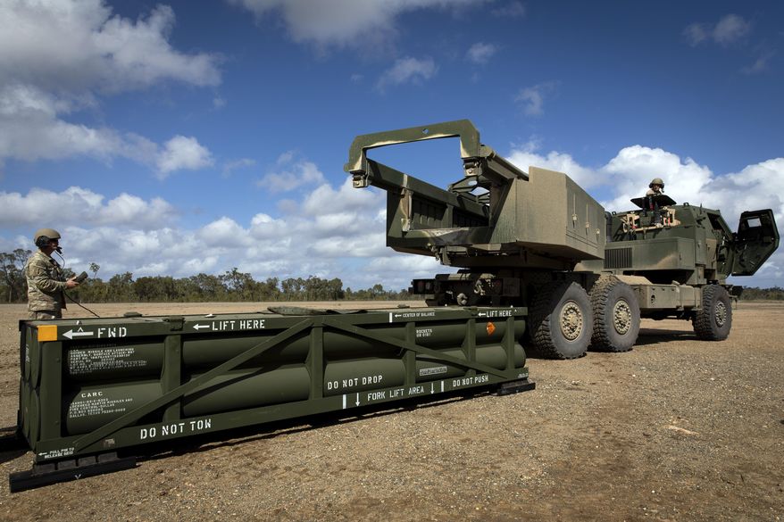 In this image provided by the U.S. Army, Sgt. Ian Ketterling, gunner for Alpha Battery, 1st Battalion, 3rd Field Artillery Regiment, 17th Field Artillery Brigade, prepares the crane for loading the Army Tactical Missile System (ATACMS) onto the High Mobility Artillery Rocket System (HIMARS) in Queensland, Australia, on July 26, 2023. (Sgt. 1st Class Andrew Dickson/U.S. Army via AP) **FILE**