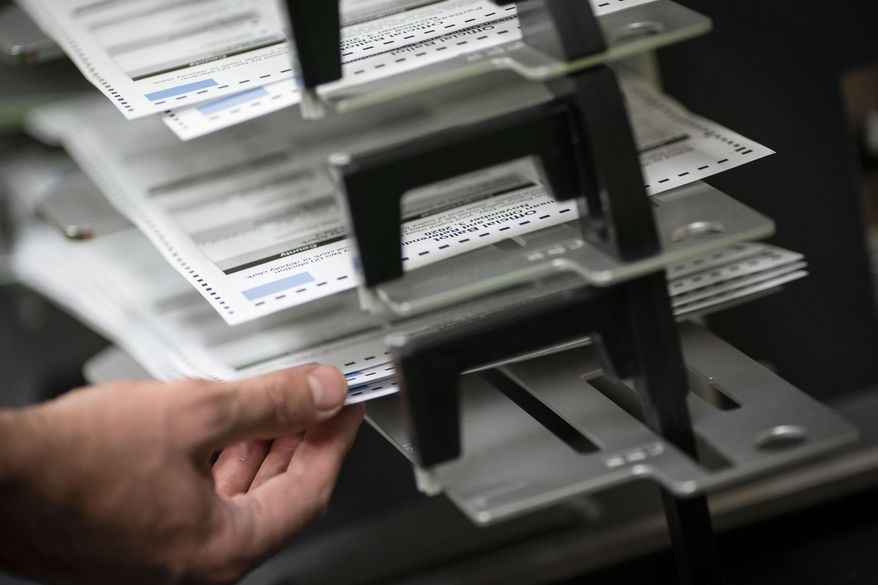 Poll workers sort out early and absentee ballots at the Kenosha Municipal building on Election Day, in Kenosha, Wis., Nov. 3, 2020. (AP Photo/Wong Maye-E, File)