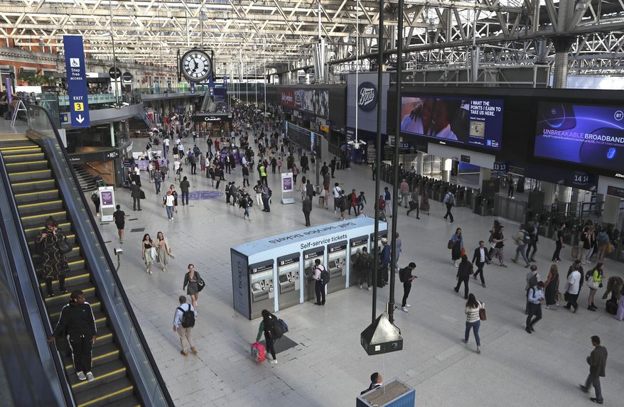 Commuters walk inside Waterloo station in London, June 20, 2022. (AP Photo/Tony Hicks), File)