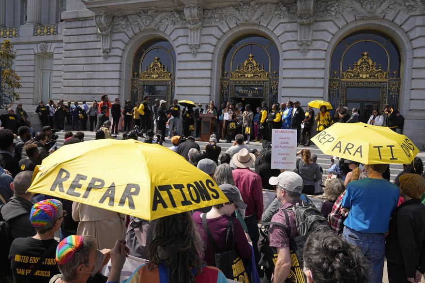 People listen during a rally in support of reparations for African Americans outside City Hall in San Francisco, Tuesday, Sept. 19, 2023. (AP Photo/Eric Risberg, File)