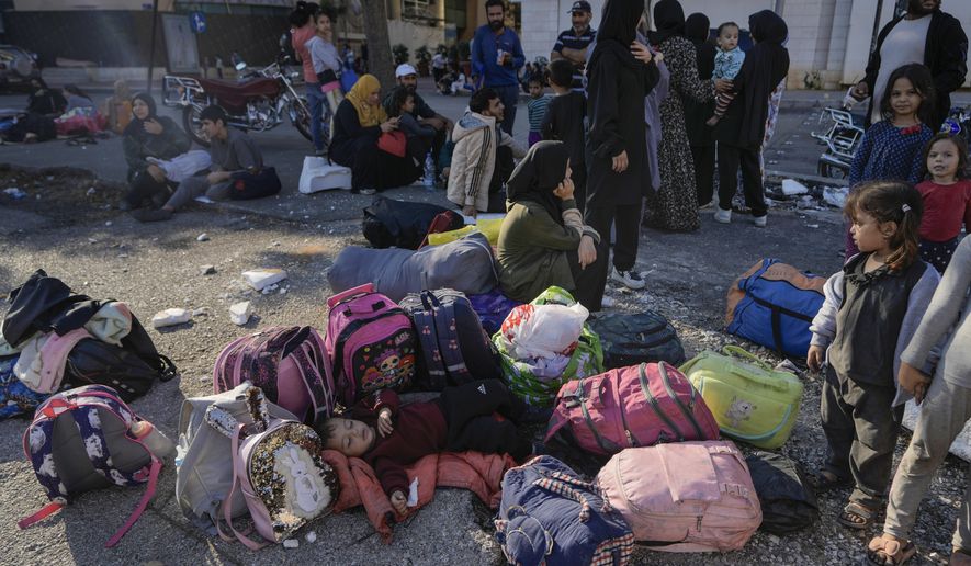 Families gather in Martyrs' square after fleeing the Israeli airstrikes in Beirut's southern suburbs, Saturday, Sept. 28, 2024. (AP Photo/Bilal Hussein)