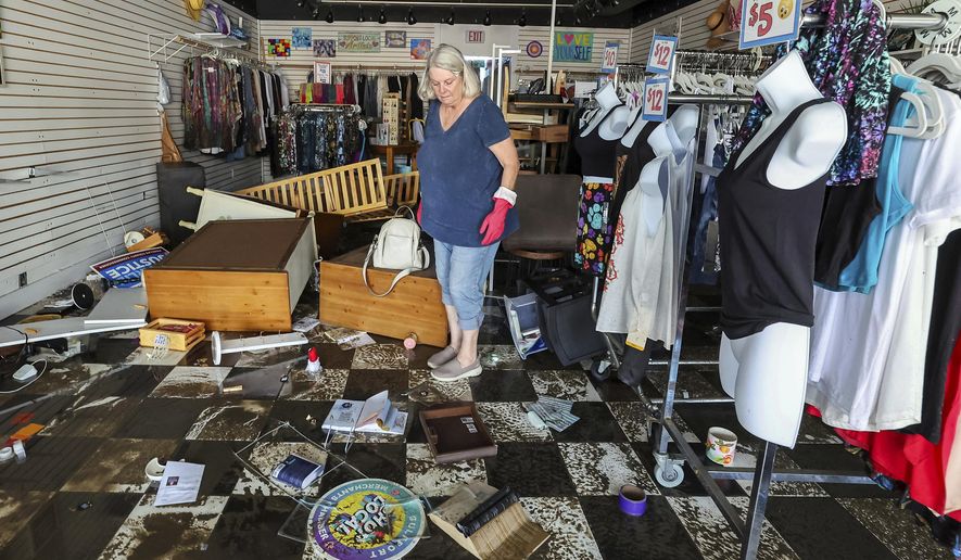 Jill Rice looks over the damage to her store caused by flooding from Hurricane Helene on Friday, Sept. 27, 2024, in Gulfport, Fla. (AP Photo/Mike Carlson)