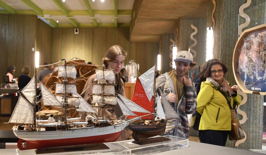 Visitors attend an exhibition of model ships made by the Madagascar company Le Village and on display at the Homo Faber 2024 show in Venice, Italy, Friday, Sept. 13, 2024.(AP Photo/Luigi Costantini)