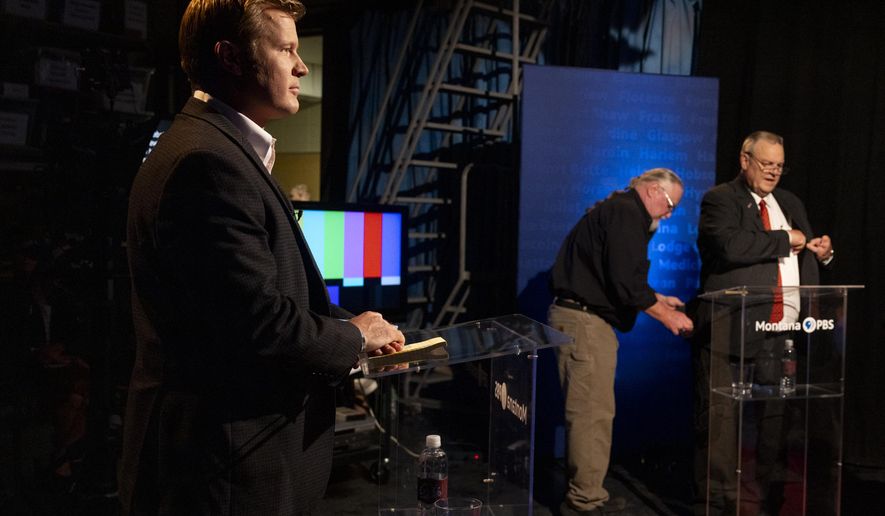 Tim Sheehy, left, prepares to debate U.S. Sen. Jon Tester, right, on campus at the University of Montana in Missoula, Mont., Monday, Sept. 30, 2024. (Ben Allan Smith/The Missoulian via AP)