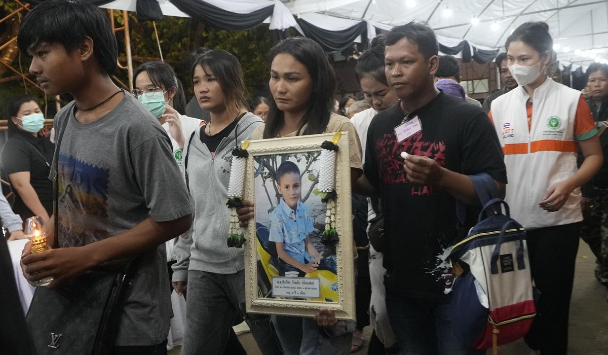 NextImg:Memories and prayers are shared at a small-town funeral for the victims of horrific Thai bus fire