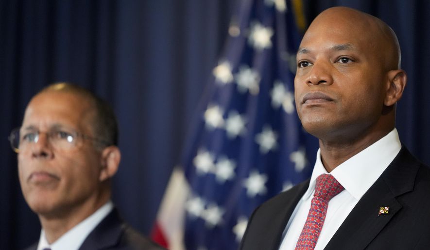 Maryland Gov. Wes Moore, right, flanked by Attorney General Anthony Brown, listen to a question during a press conference Tuesday, Sept. 24, 2024, in Baltimore. (AP Photo/Stephanie Scarbrough, File)