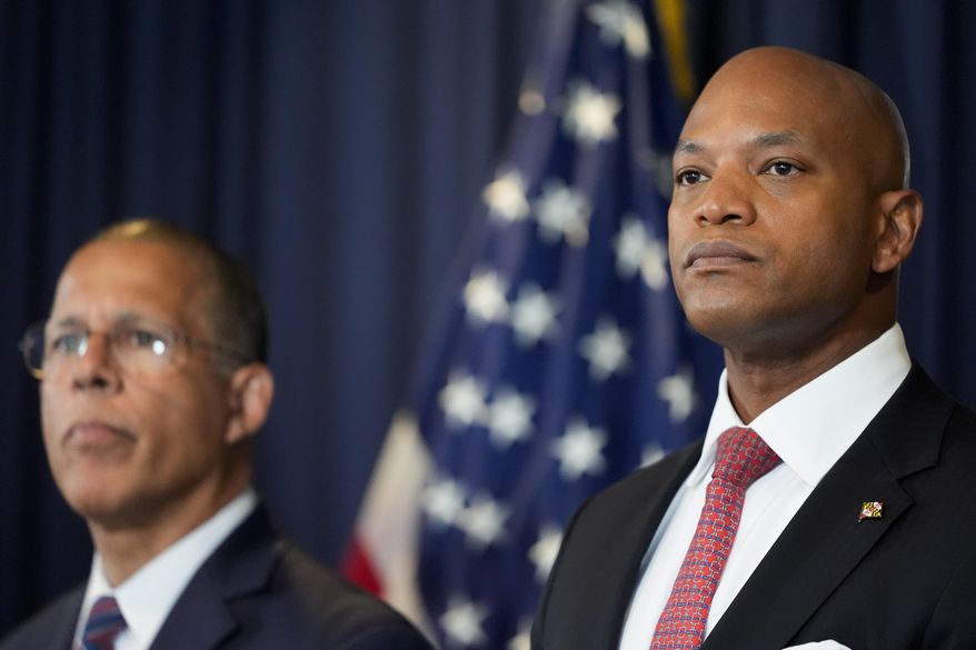 Maryland Gov. Wes Moore, right, flanked by Attorney General Anthony Brown, listen to a question during a press conference Tuesday, Sept. 24, 2024, in Baltimore. (AP Photo/Stephanie Scarbrough, File)