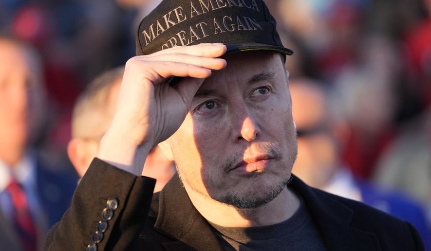 Tesla and SpaceX CEO Elon Musk listens as Republican presidential nominee former President Donald Trump speaks at a campaign event at the Butler Farm Show, Saturday, Oct. 5, 2024, in Butler, Pa. (AP Photo/Alex Brandon)