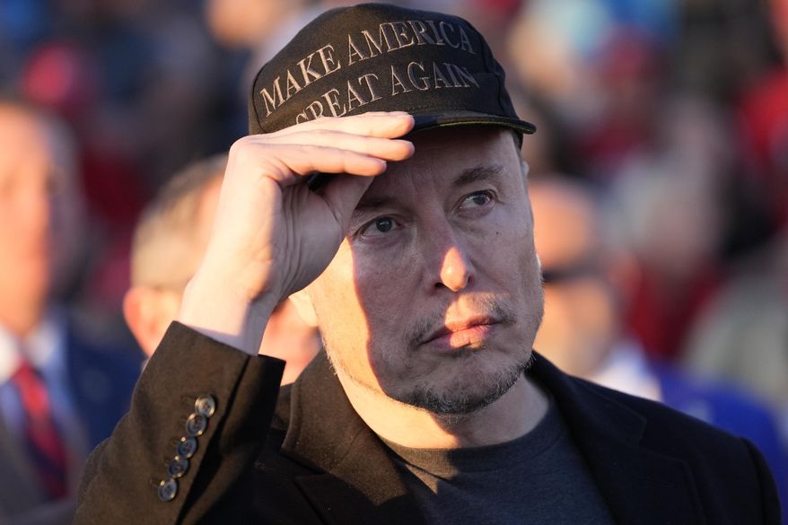 Tesla and SpaceX CEO Elon Musk listens as Republican presidential nominee former President Donald Trump speaks at a campaign event at the Butler Farm Show, Saturday, Oct. 5, 2024, in Butler, Pa. (AP Photo/Alex Brandon)
