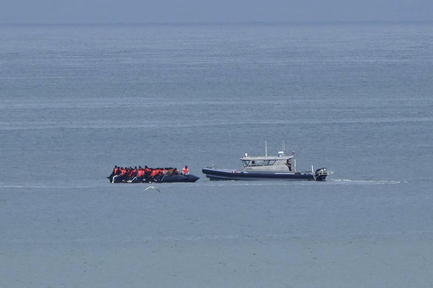 A boat thought to carry migrants is escorted by a vessel from the French Gendarmerie Nationale in the English Channel off Wimereux beach, France, Wednesday, Sept. 4, 2024. (AP Photo/Nicolas Garriga, File)