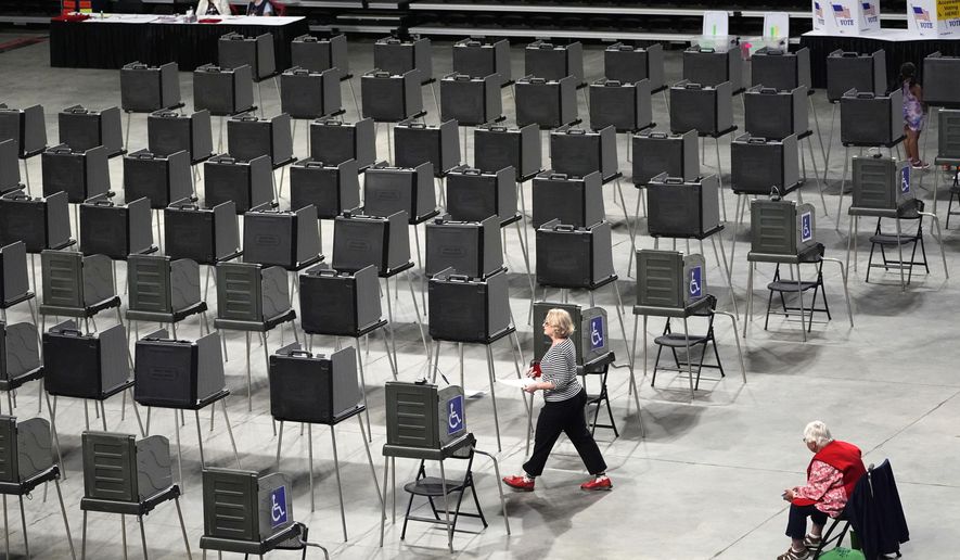 A voter has dozens of booths to choose from as she prepares to cast her ballot in Maine's primary election, Tuesday, June 11, 2024, in Bangor, Maine. (AP Photo/Robert F. Bukaty, File)