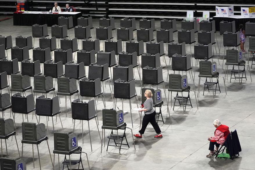 A voter has dozens of booths to choose from as she prepares to cast her ballot in Maine's primary election, Tuesday, June 11, 2024, in Bangor, Maine. (AP Photo/Robert F. Bukaty, File)