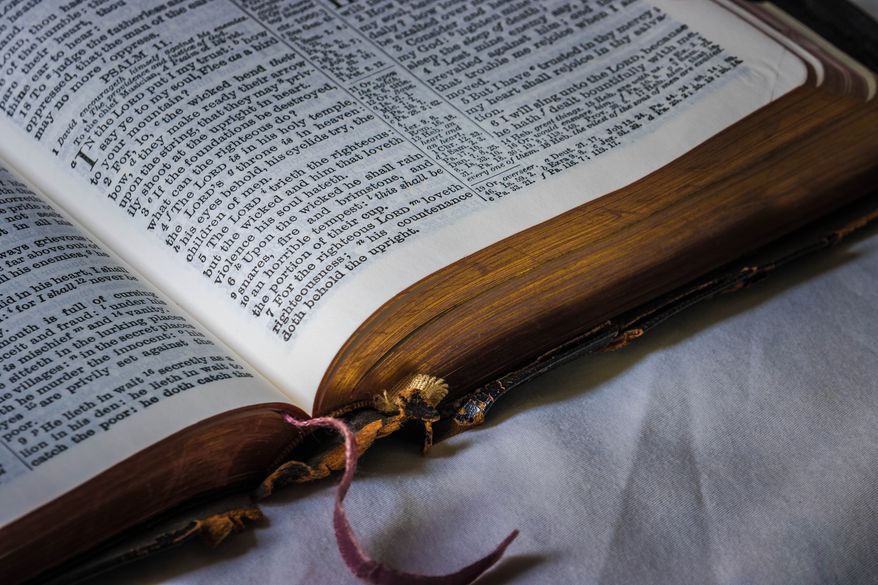 A Bible opened to the Book of Psalms, chapter 11, Old Testament of the Holy Scriptures. File photo credit: joshimerbin via Shutterstock.