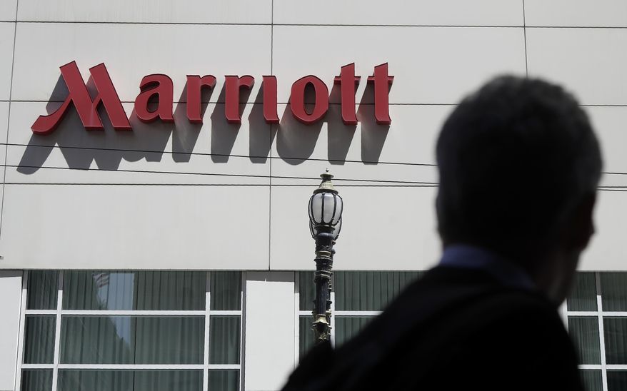 A person walks past the San Francisco Marriott Union Square hotel on July 11, 2019, in San Francisco. (AP Photo/Jeff Chiu, File)
