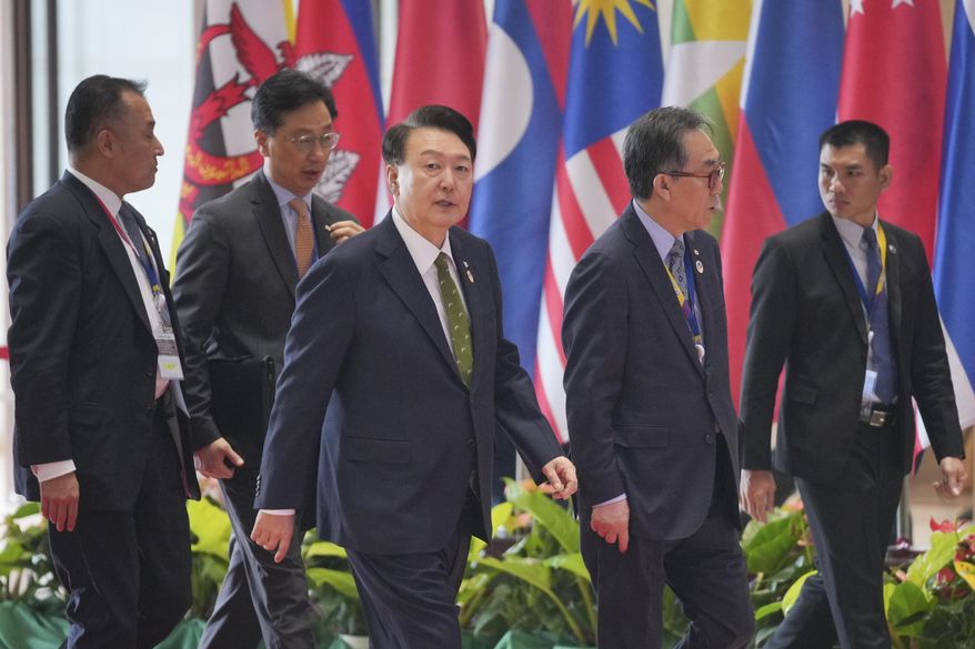 South Korean President Yoon Suk-yeol, center, arrives ahead of the 19th East Asia Summit in Vientiane, Laos, Friday, Oct. 11, 2024. (AP Photo/Dita Alangkara)