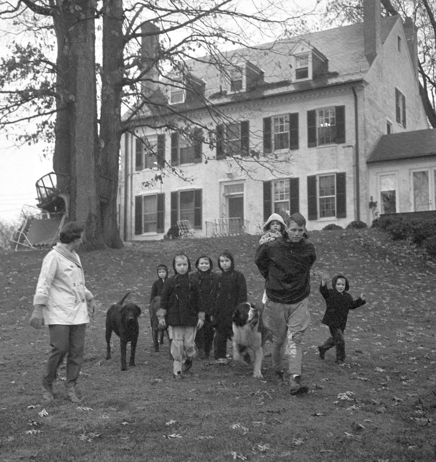 Ethel Kennedy, from left, with children Courtney, 3, Kathleen, 8, Joseph Patrick, 7, Bobby, 5, husband Robert F. Kennedy, with 18-month-old Michael on his back, and David, 4, take a walk at the Kennedy home in McLean, Va., on Dec. 30, 1959. (AP Photo/Henry Griffin, File)