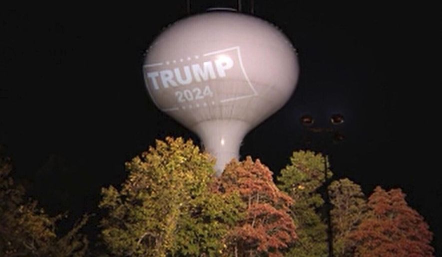 In this recently undated photo shows a former President Donald Trump campaign endorsement projected on a water tower in Hanson, Mass. (WCVB-TV via AP)