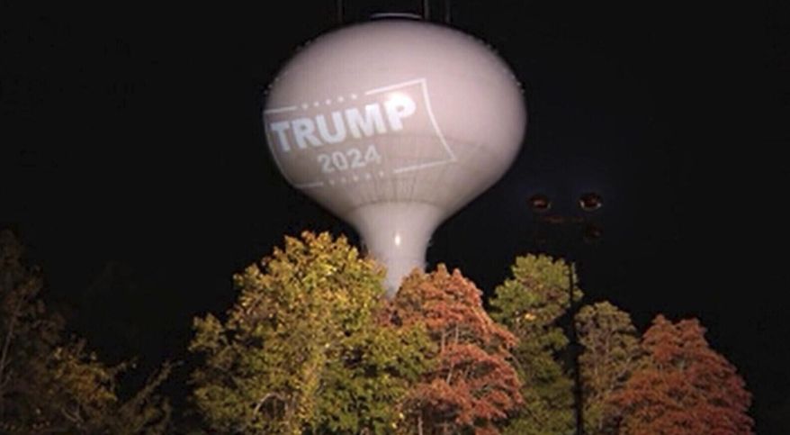 In this recently undated photo shows a former President Donald Trump campaign endorsement projected on a water tower in Hanson, Mass. (WCVB-TV via AP)